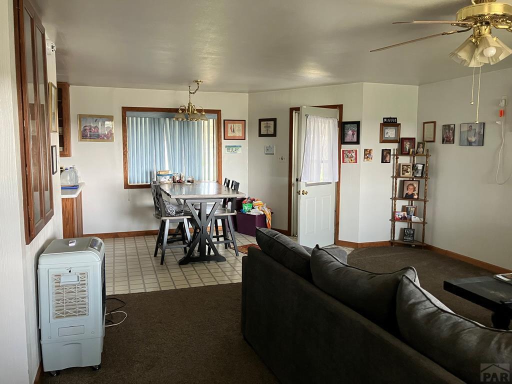 915 Maple Avenue La Junta, CO 81050 - Photo 4 of 34 a living room with furniture and a dining table with kitchen view