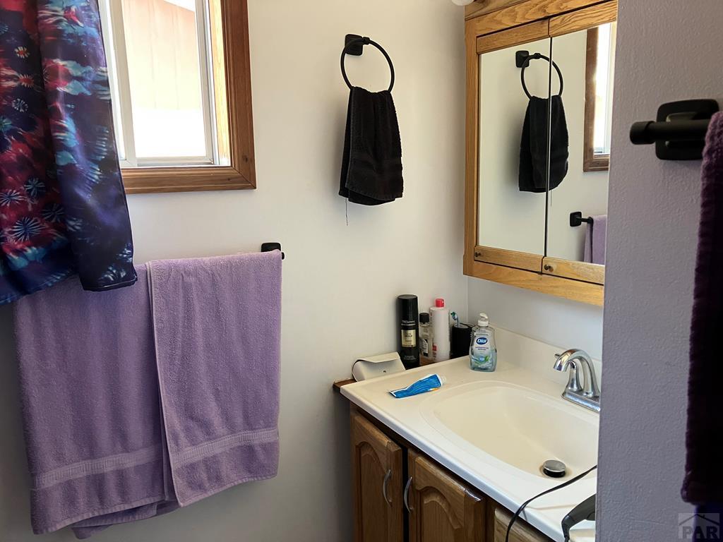 915 Maple Avenue La Junta, CO 81050 - Photo 9 of 34 a bathroom with a sink and mirror