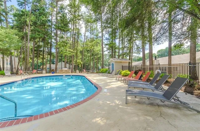 a view of a house with swimming pool and sitting area