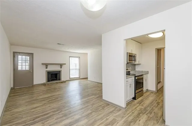 a view of a kitchen with a stove cabinets and wooden floor