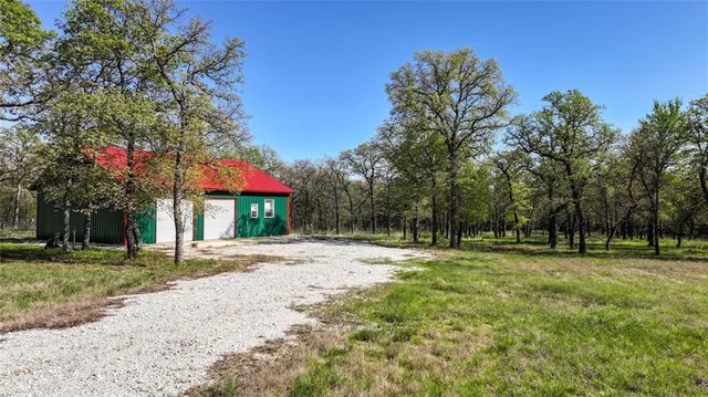 a backyard of a house with lots of green space and trees