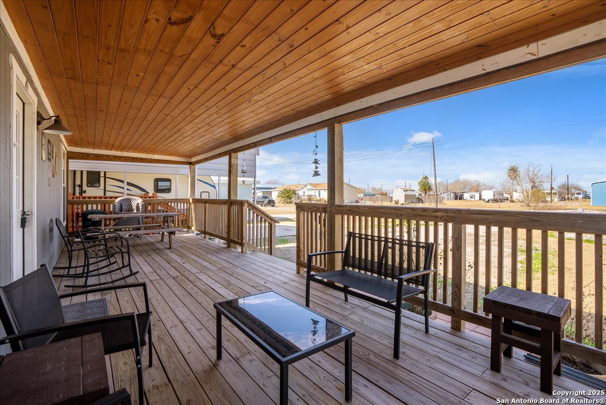 129-131 Ling Road Rockport, TX 78382 - Photo 19 of 38 a view of a chairs and table on the deck