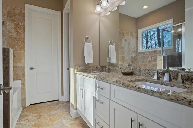 a bathroom with a double vanity sink and a mirror