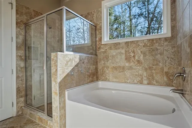 a bathroom with a bathtub and shower