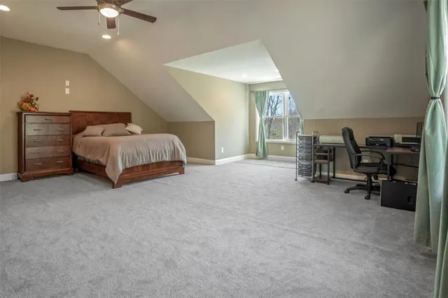 a spacious bedroom with a bed and a chandelier