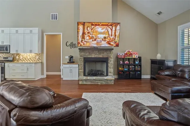 a living room with furniture and a fireplace