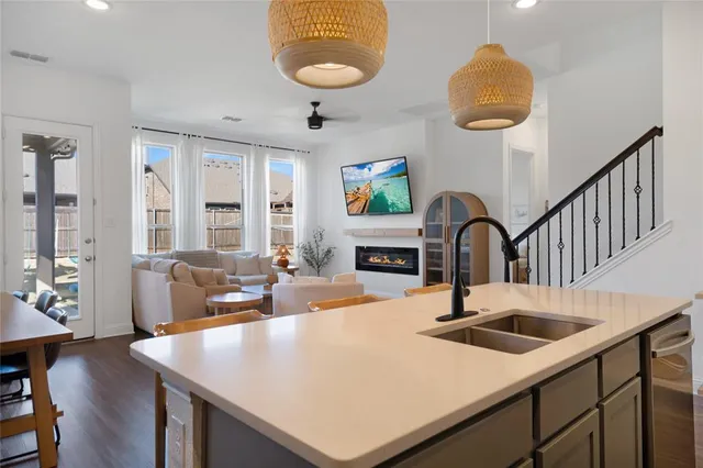a kitchen with a table chairs and a refrigerator