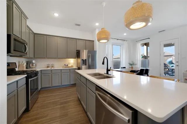 a kitchen with a stove a sink and a refrigerator