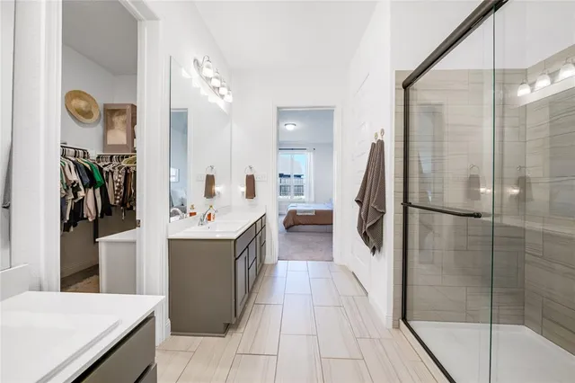 a large kitchen with a sink and refrigerator