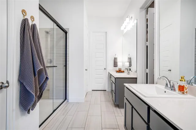 a bathroom with a double vanity sink a toilet and a mirror
