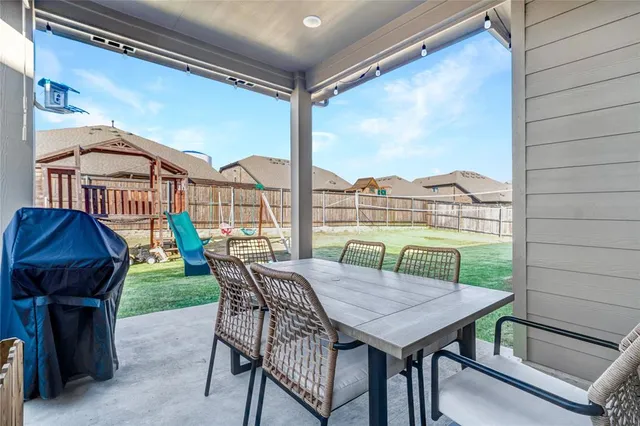 a view of a balcony with furniture and a floor to ceiling window