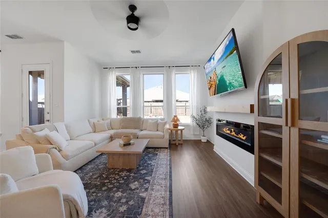 a living room with furniture fireplace and a large window