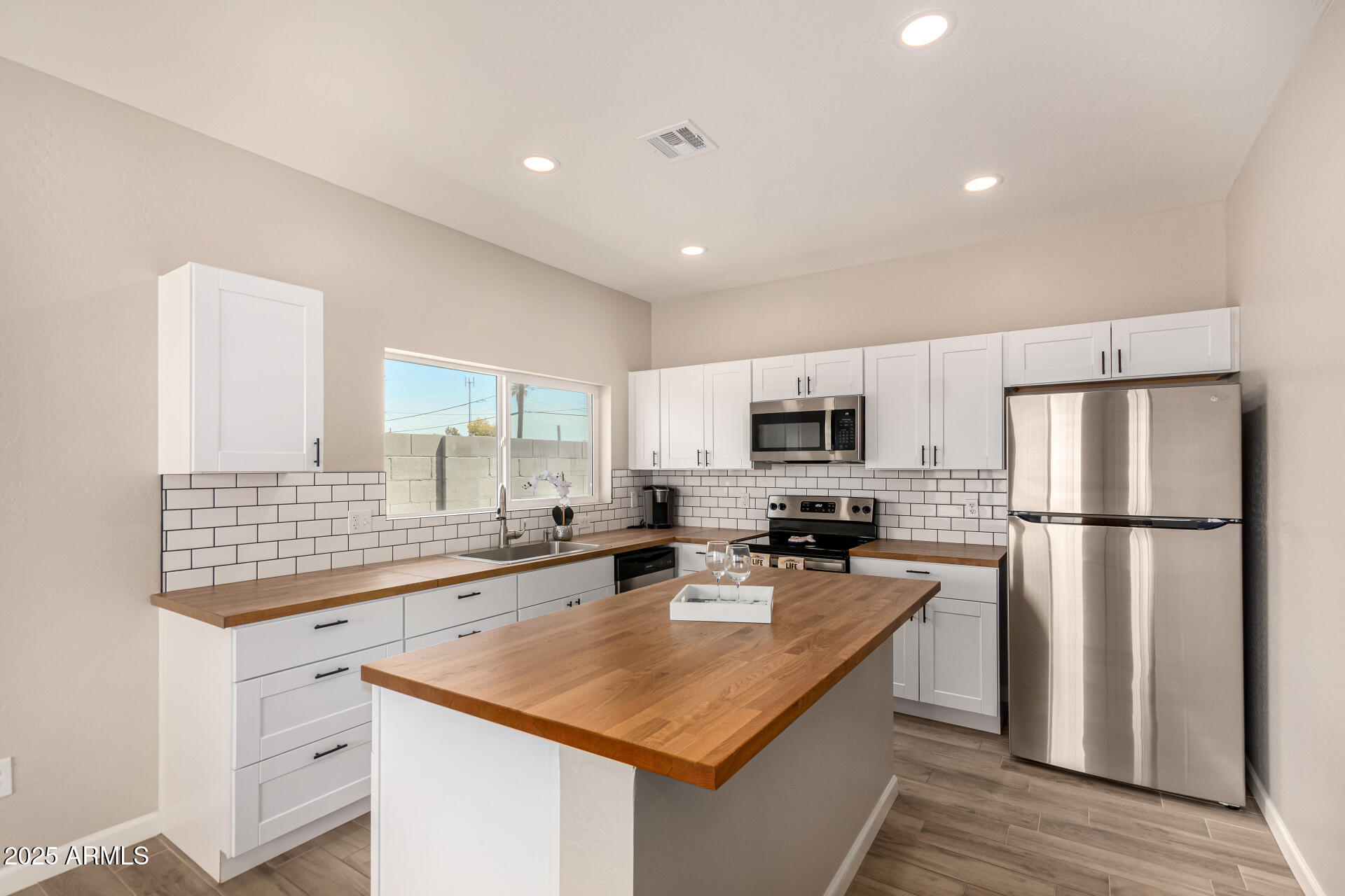2746 West Pima Street, Unit 2 Phoenix, AZ 85009 - Photo 10 of 25 a kitchen with stainless steel appliances granite countertop a sink a stove and a refrigerator