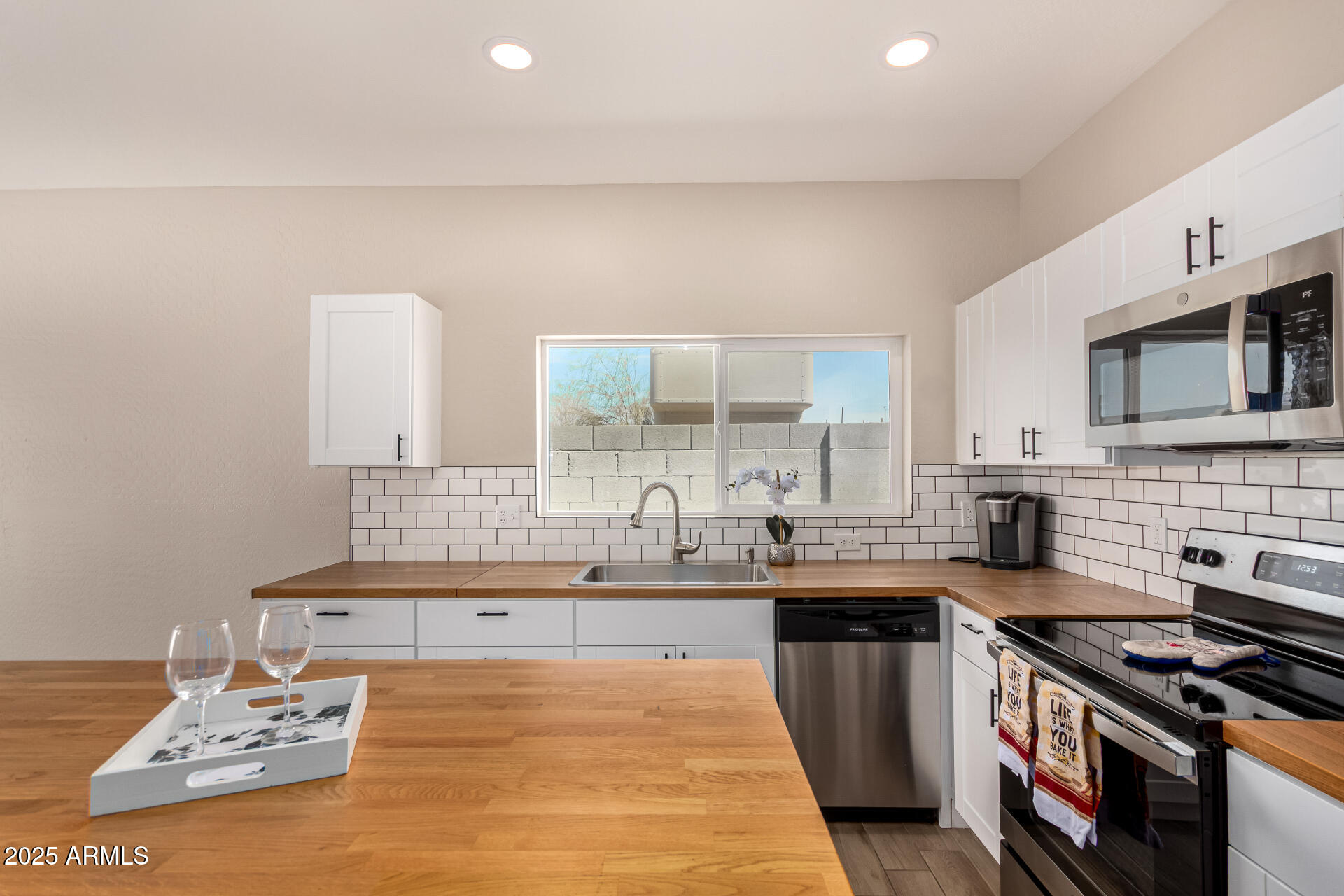 2746 West Pima Street, Unit 2 Phoenix, AZ 85009 - Photo 11 of 25 a kitchen with stainless steel appliances a sink stove and cabinets