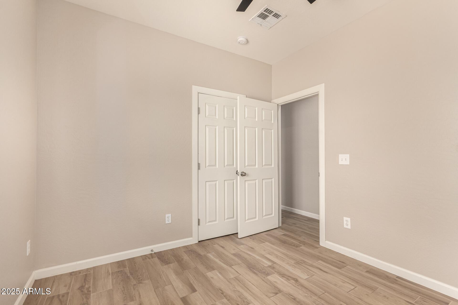 2746 West Pima Street, Unit 2 Phoenix, AZ 85009 - Photo 18 of 24 a view of an empty room with wooden floor