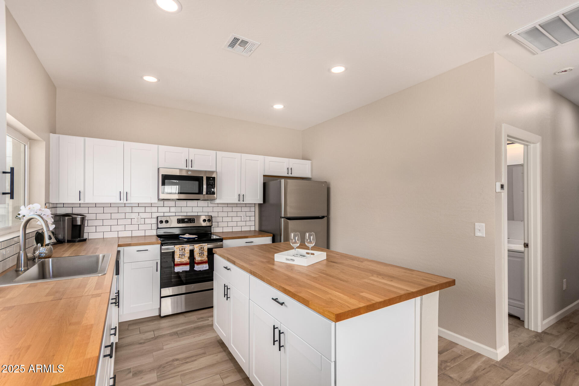 2746 West Pima Street, Unit 2 Phoenix, AZ 85009 - Photo 8 of 25 a kitchen with stainless steel appliances a sink stove and refrigerator
