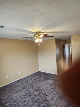 a view of a big room with closet and a chandelier fan