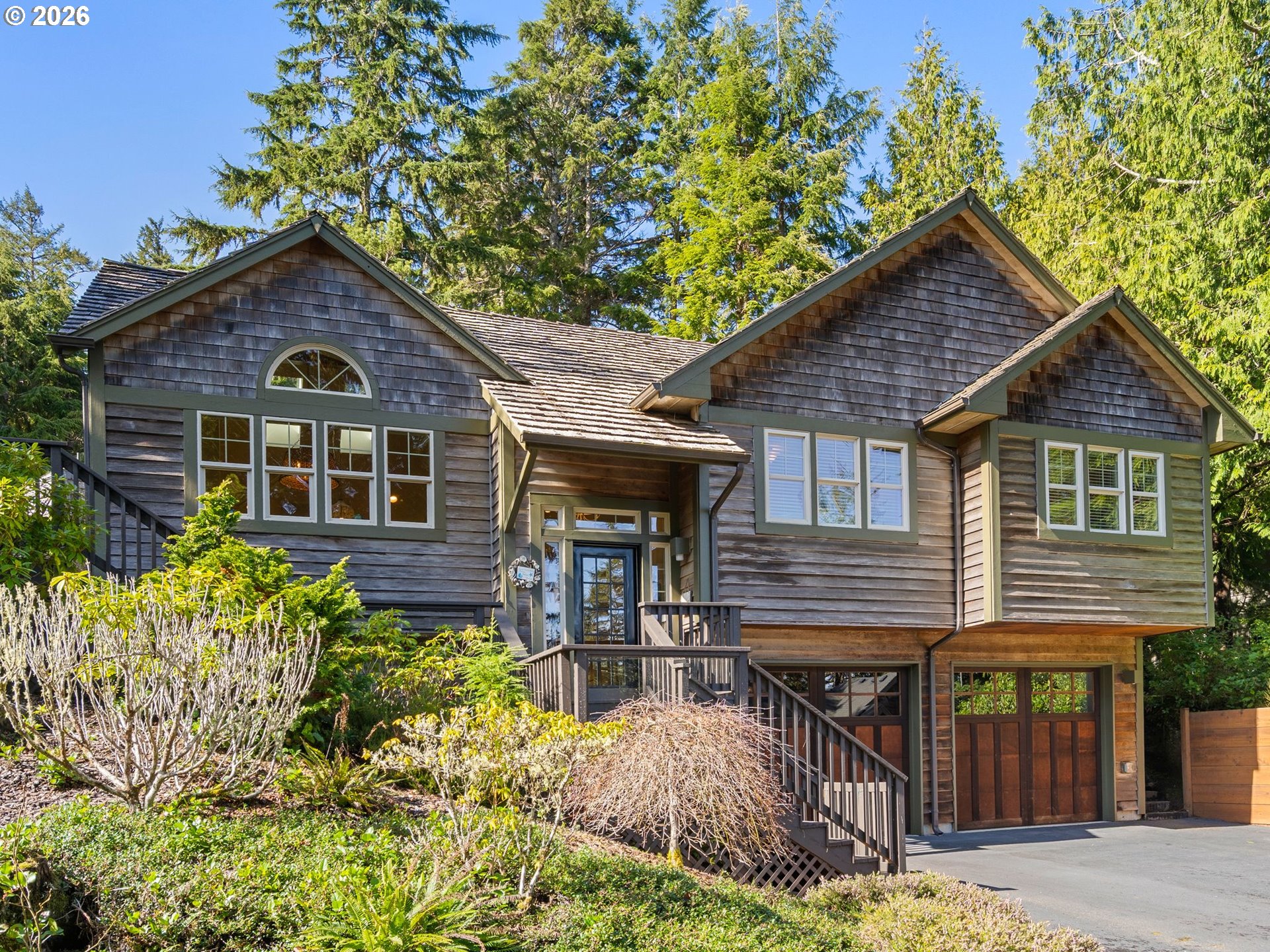 10 Big Tree Road Gleneden Beach, OR 97388 - Photo 1 of 48 a front view of a house with garden