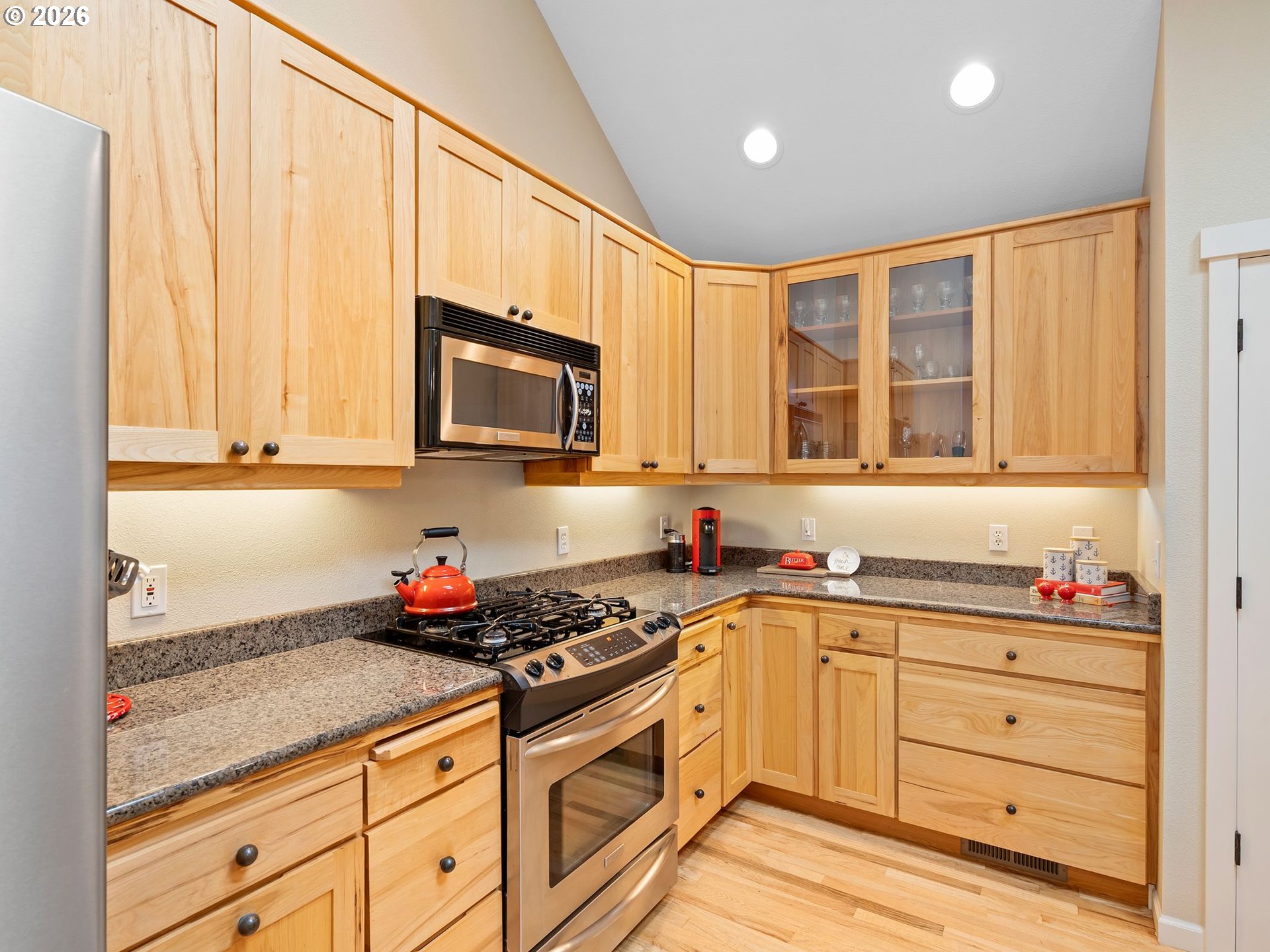 10 Big Tree Road Gleneden Beach, OR 97388 - Photo 11 of 48 a kitchen with granite countertop white cabinets stainless steel appliances a sink and a window