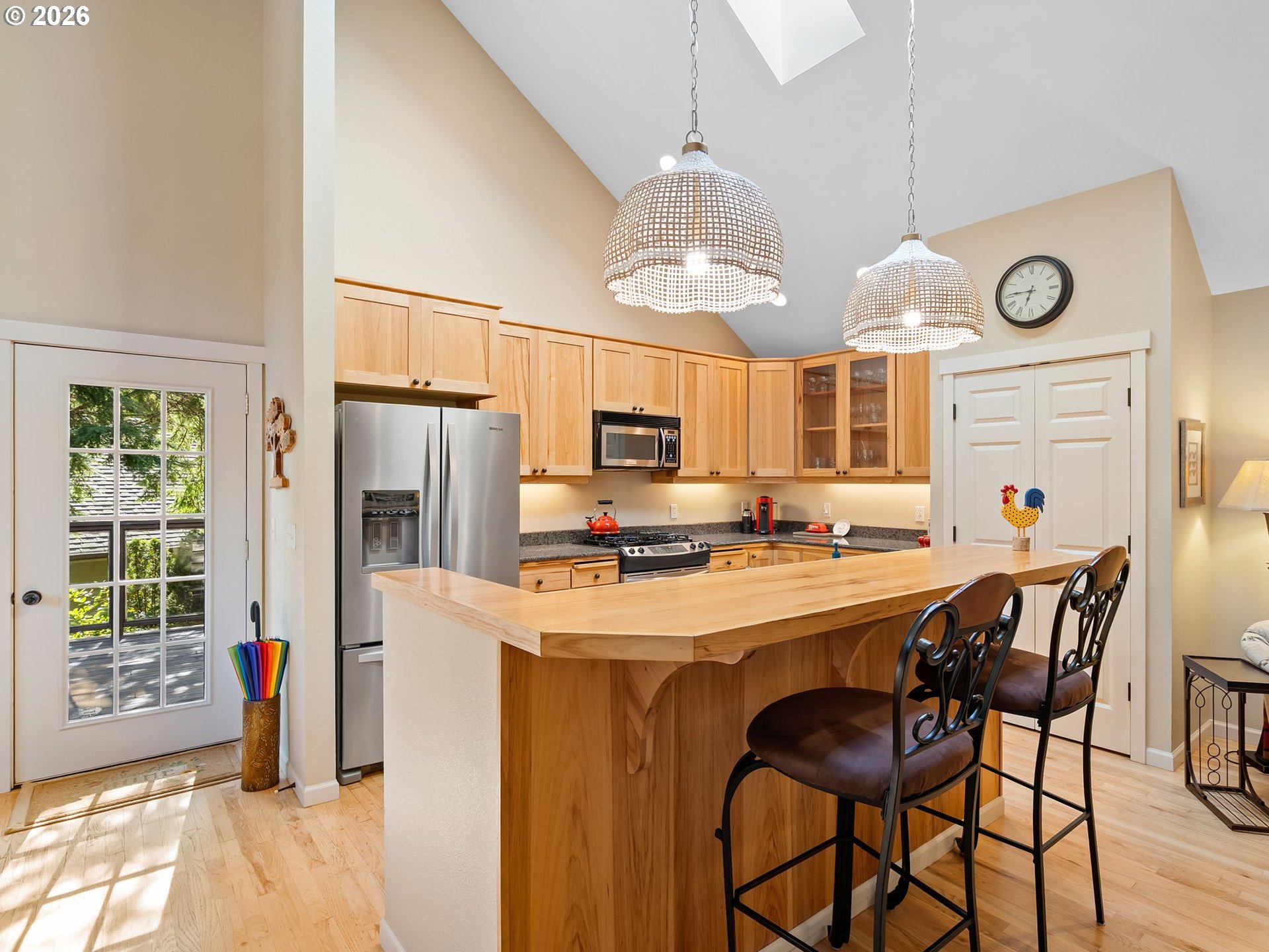 10 Big Tree Road Gleneden Beach, OR 97388 - Photo 14 of 48 a kitchen with stainless steel appliances a table chairs and a window