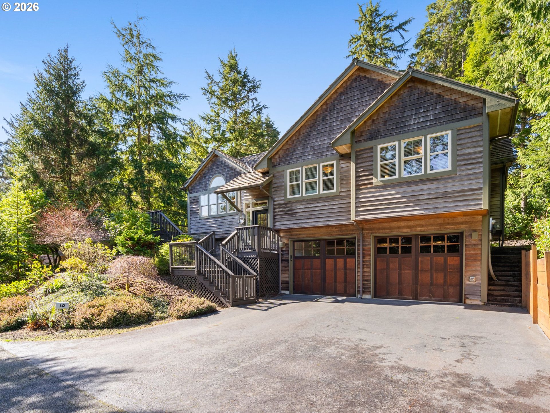 10 Big Tree Road Gleneden Beach, OR 97388 - Photo 2 of 48 a front view of a house with a yard and garage