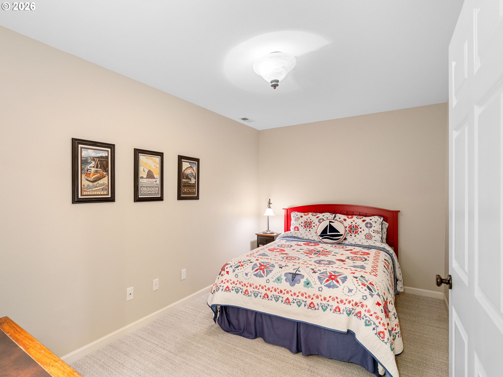 10 Big Tree Road Gleneden Beach, OR 97388 - Photo 28 of 48 a bedroom with a large bed and a chandelier