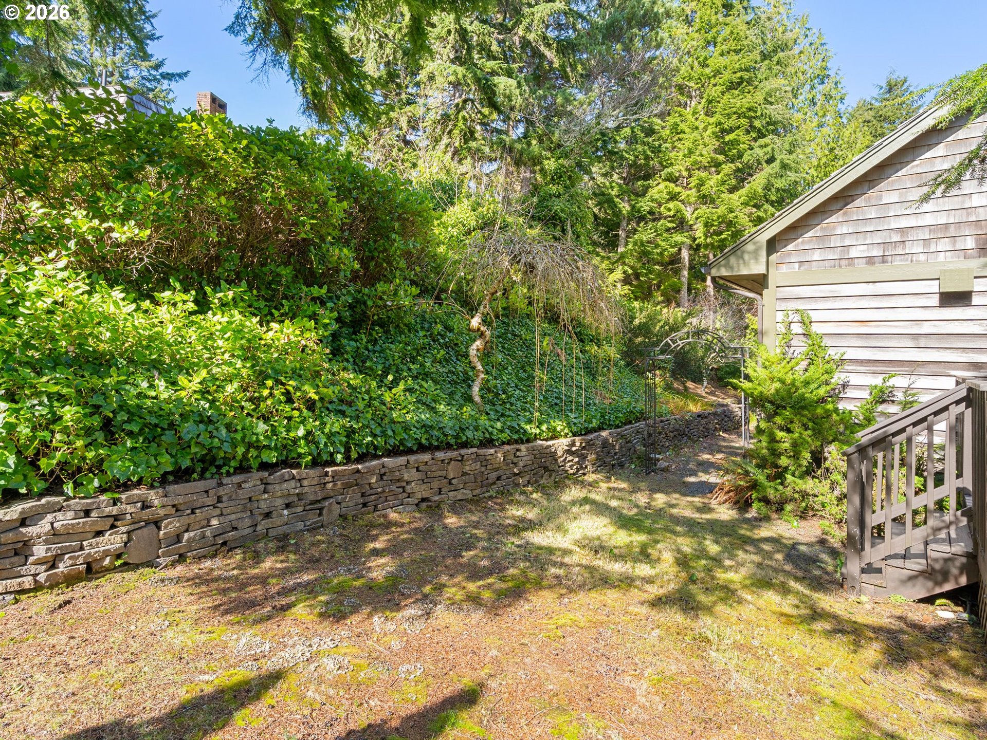 10 Big Tree Road Gleneden Beach, OR 97388 - Photo 39 of 48 a view of a backyard with plants and large trees