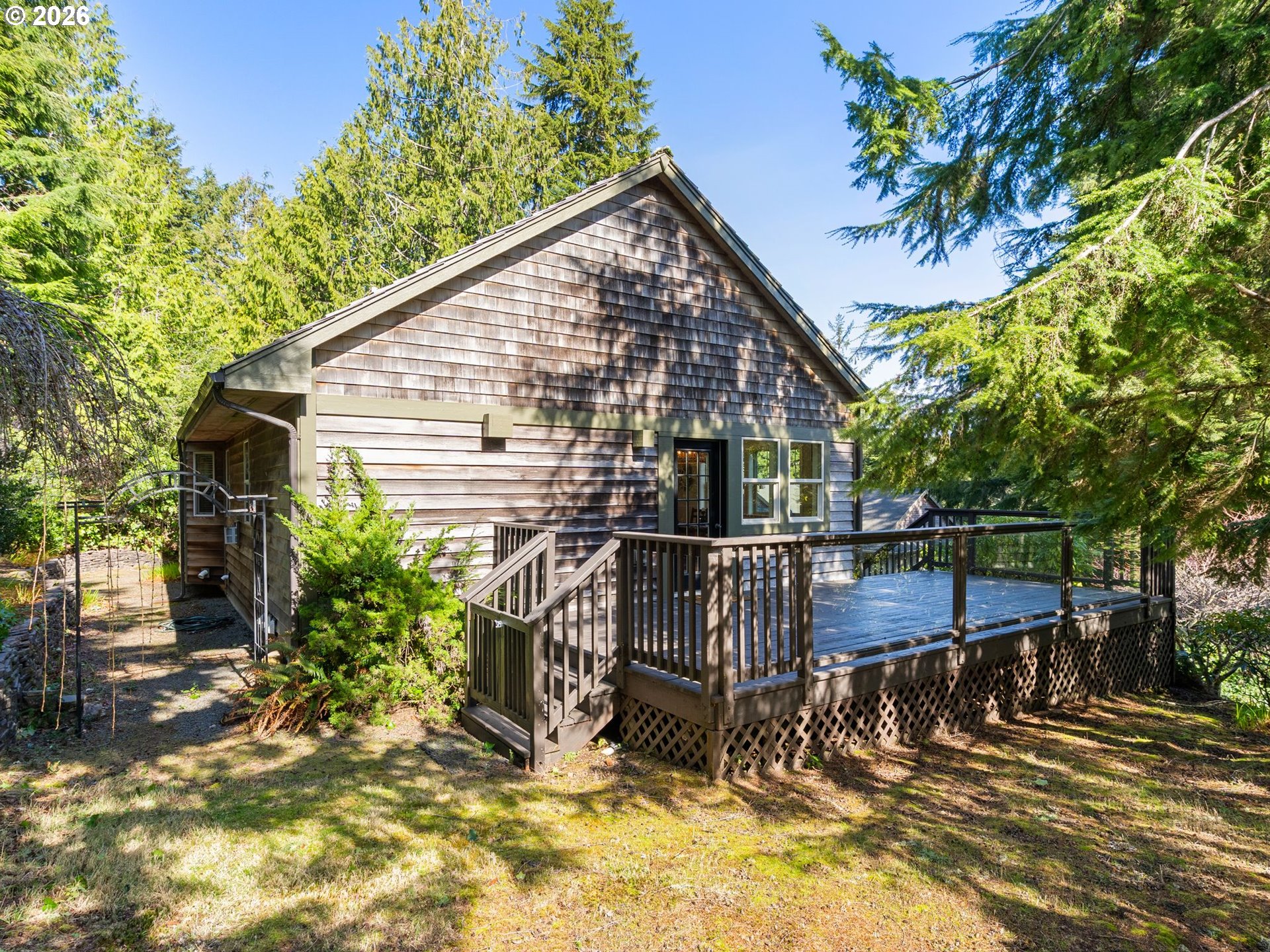 10 Big Tree Road Gleneden Beach, OR 97388 - Photo 40 of 48 a view of house with patio outdoor seating and yard