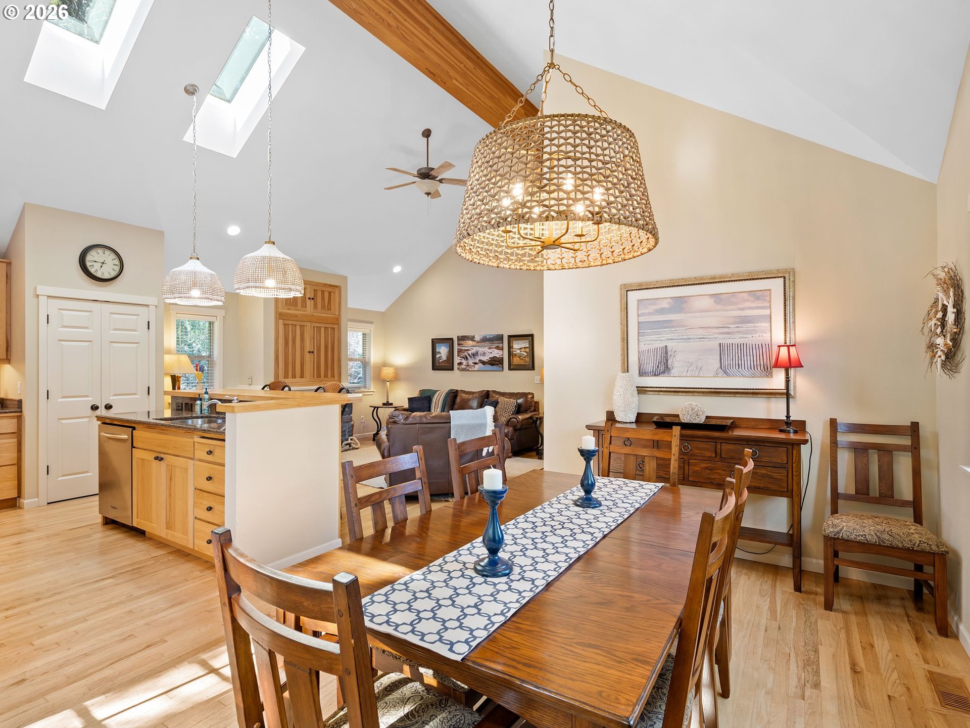 10 Big Tree Road Gleneden Beach, OR 97388 - Photo 8 of 48 a view of a dining room with furniture a chandelier and wooden floor
