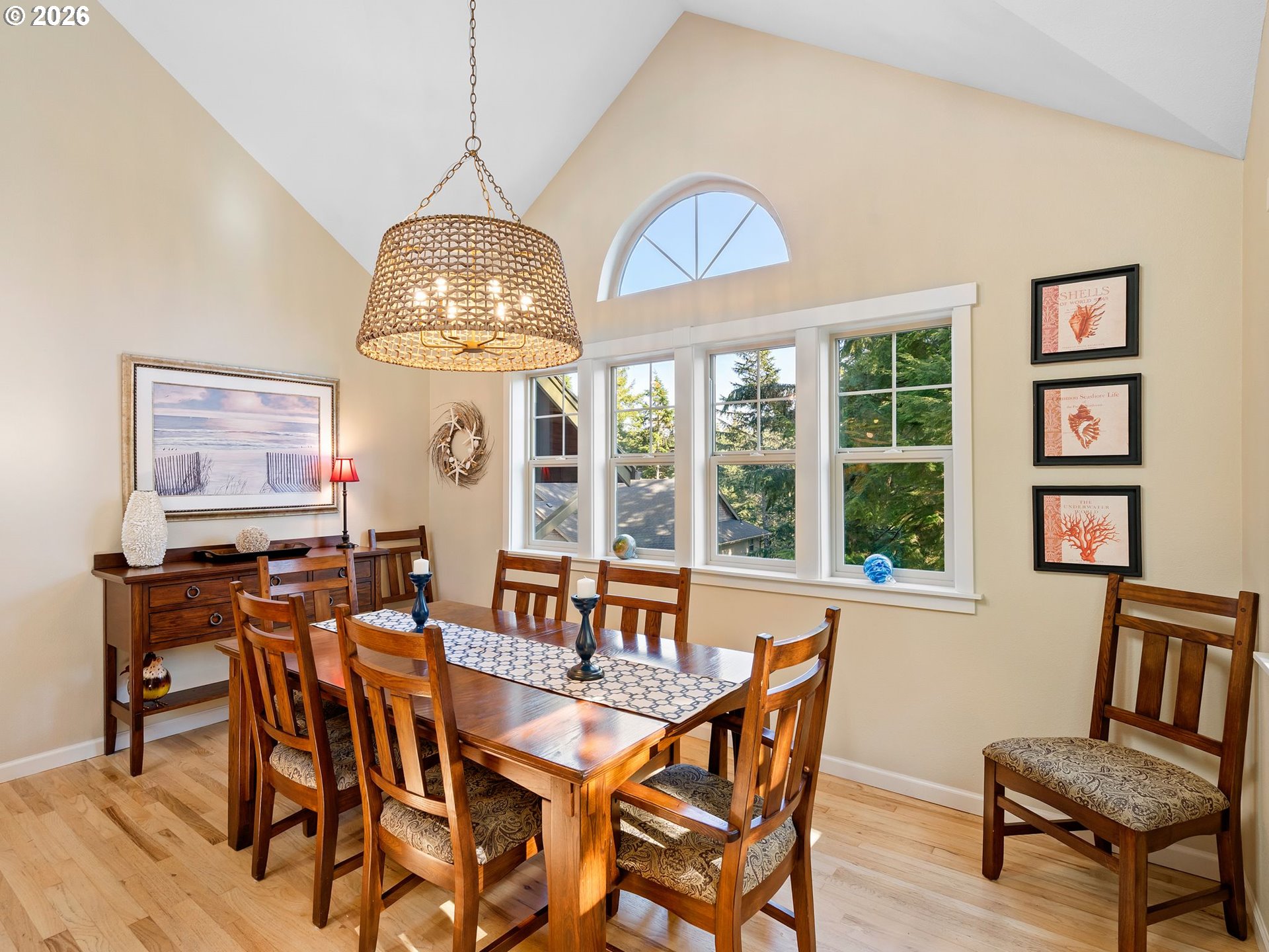 10 Big Tree Road Gleneden Beach, OR 97388 - Photo 9 of 48 a dining room with wooden floor a chandelier a wooden table and chairs