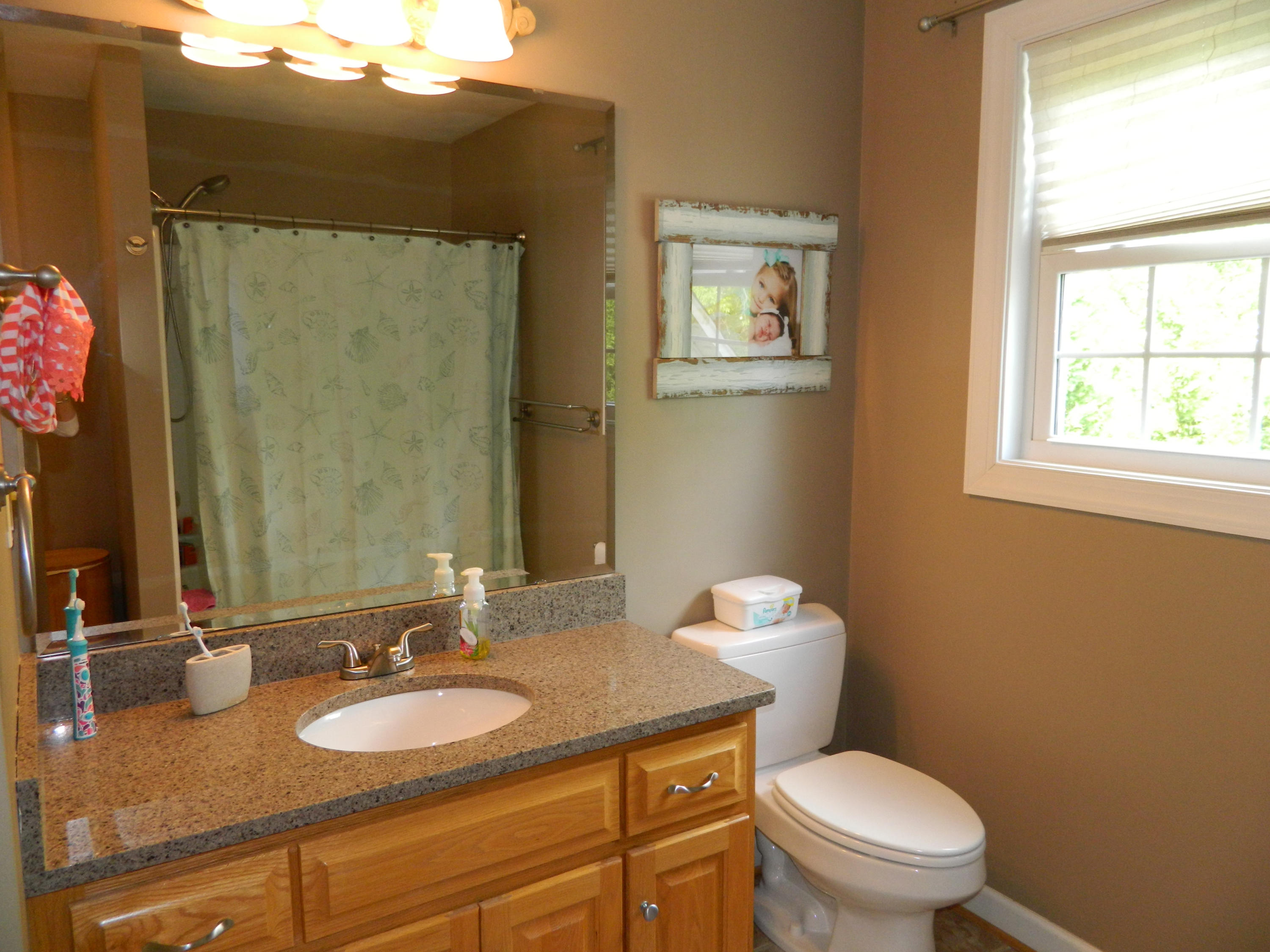 75 Cobblestone Drive Blue Ridge, VA 24064 - Photo 33 of 60 a bathroom with a granite countertop toilet a sink and a mirror