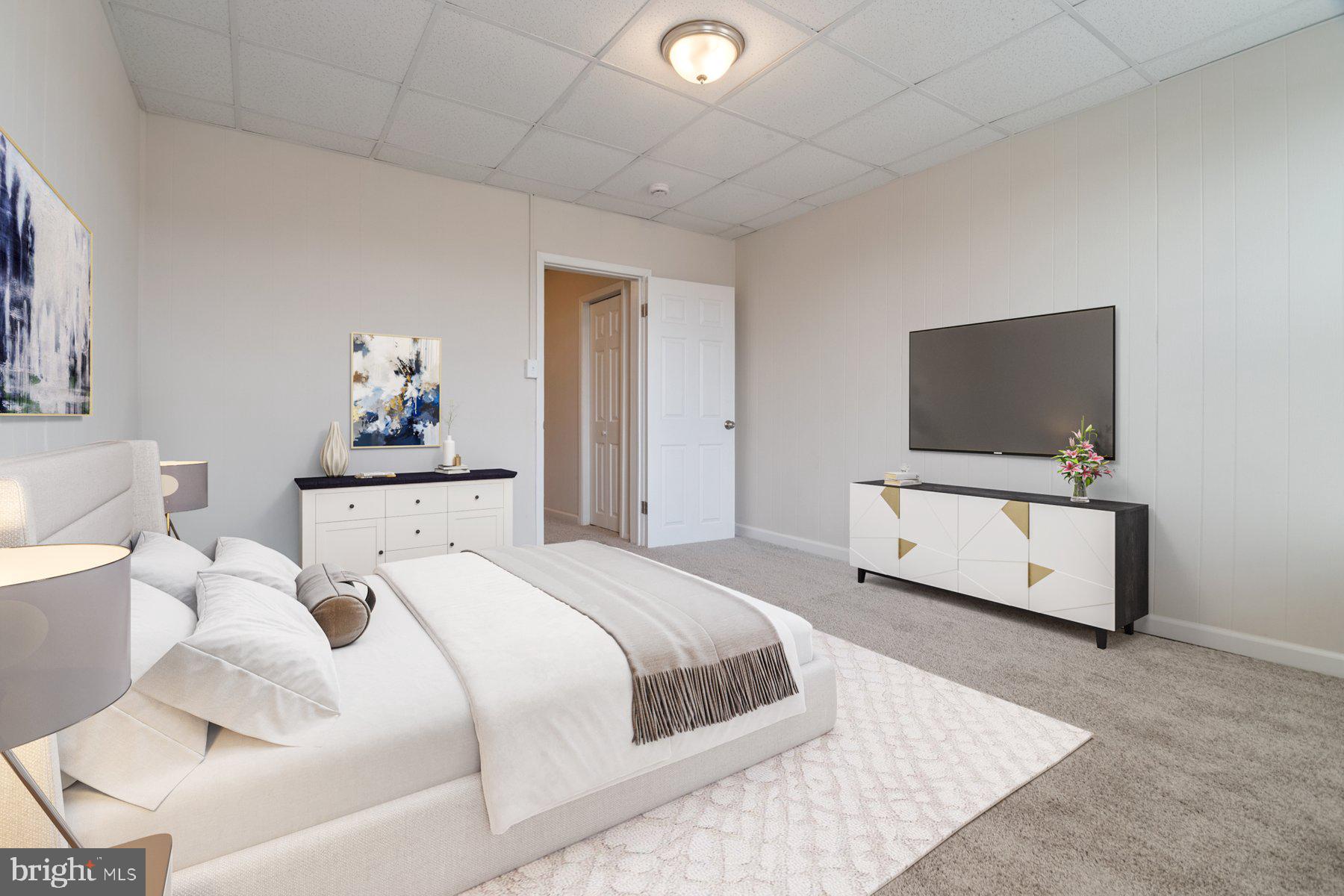 602 North Decker Avenue Baltimore, MD 21205 - Photo 12 of 16 a bedroom with a bed and flat screen tv