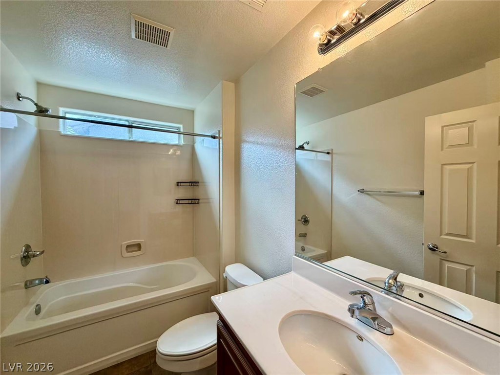11183 Ranch Valley Street Las Vegas, NV 89179 - Photo 15 of 19 A streamlined vanity and bathtub create a clean, functional bathroom space.