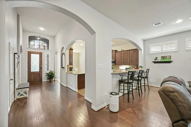 a kitchen with a refrigerator and a stove top oven