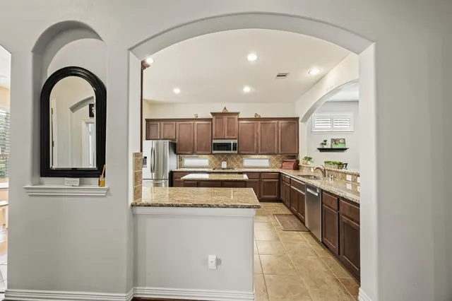 a living room with granite countertop furniture and fireplace