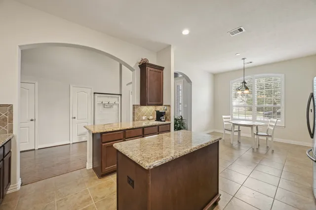 a large kitchen with stainless steel appliances and a sink