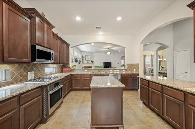 a kitchen with a sink refrigerator and cabinets