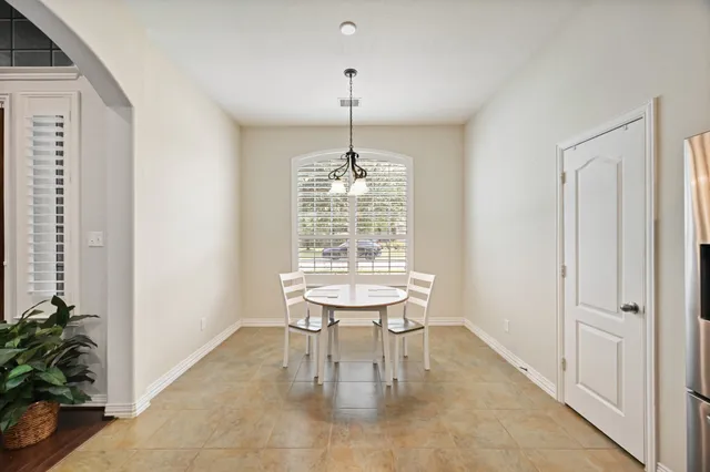 a large kitchen with a table and chairs