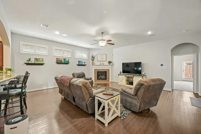 a living room with furniture a fireplace and a flat screen tv