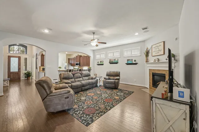 a living room with furniture a rug and a chandelier