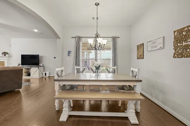 a bed room with a bed and a chandelier