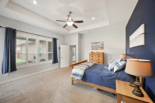 a bathroom with a tub double vanity sink and mirror