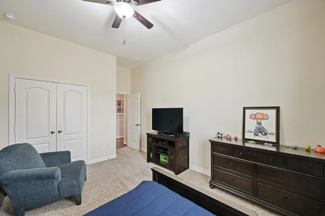 a bathroom with a granite countertop sink a toilet and shower