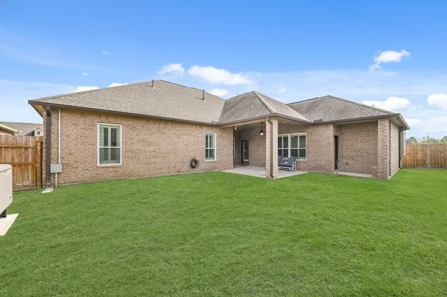 a view of a house with a yard and sitting area