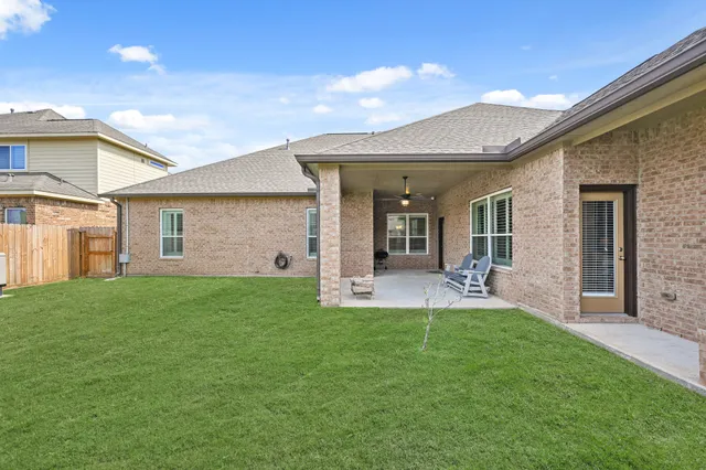 a view of a house with a yard and porch