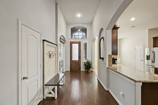 a dining room with wooden floor and chandelier