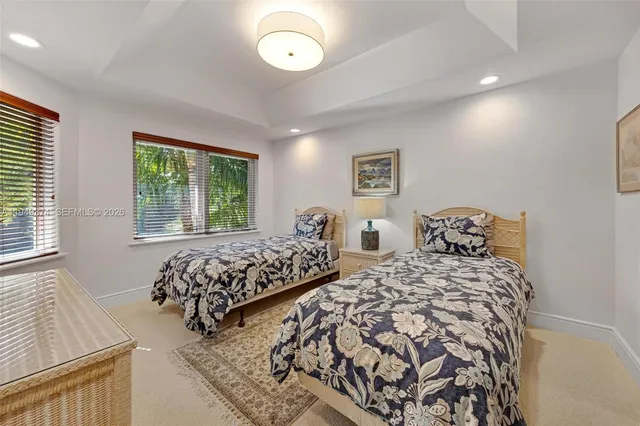 a bedroom with two beds and a large window