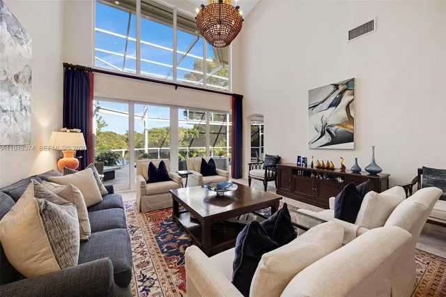 a living room with furniture and painting on the wall