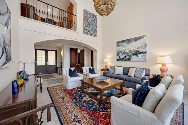 a living room with furniture and large windows