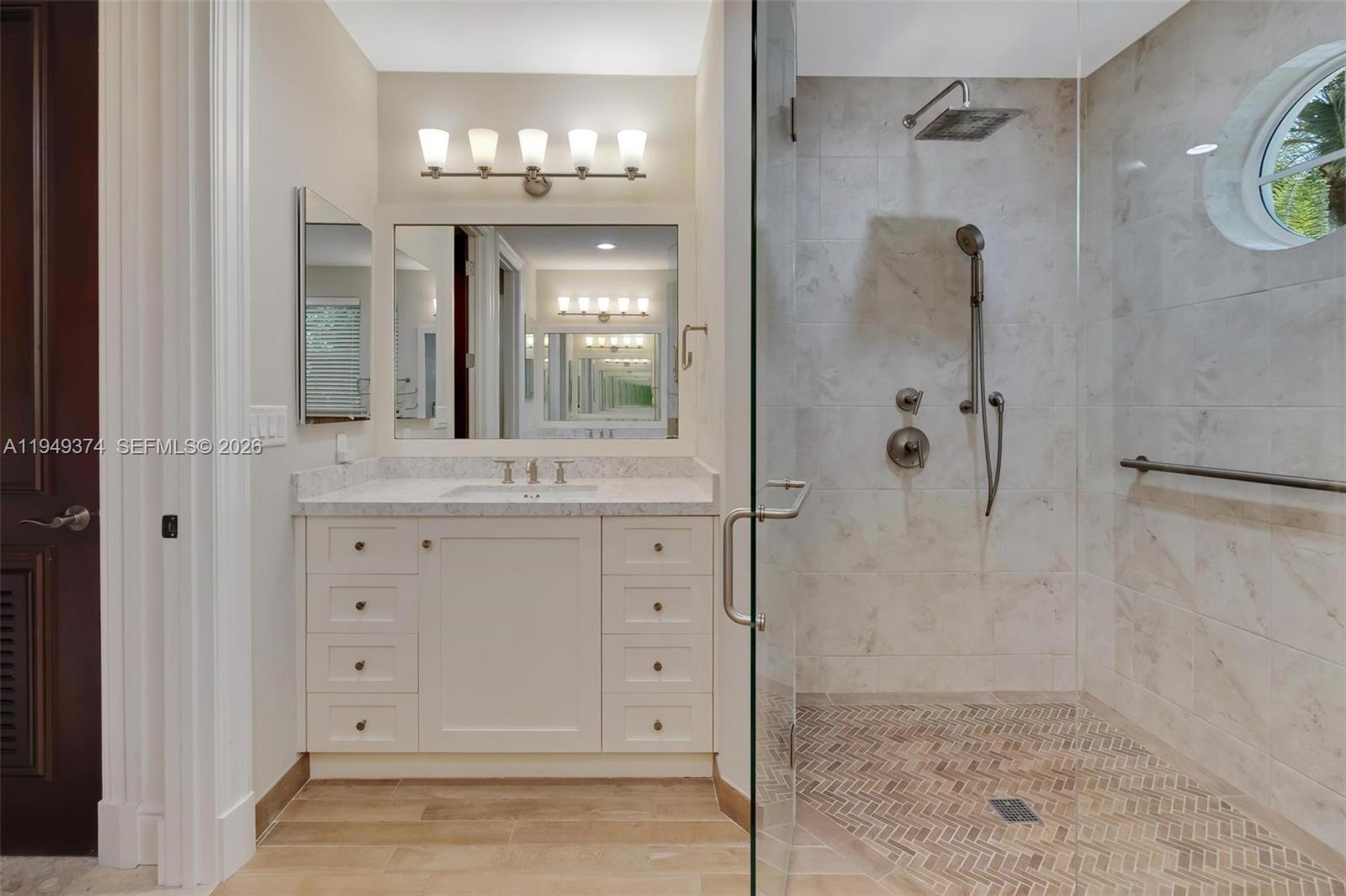 205 South Harbor Drive Key Largo, FL 33037 - Photo 26 of 50 a bathroom with a granite countertop sink a mirror and shower